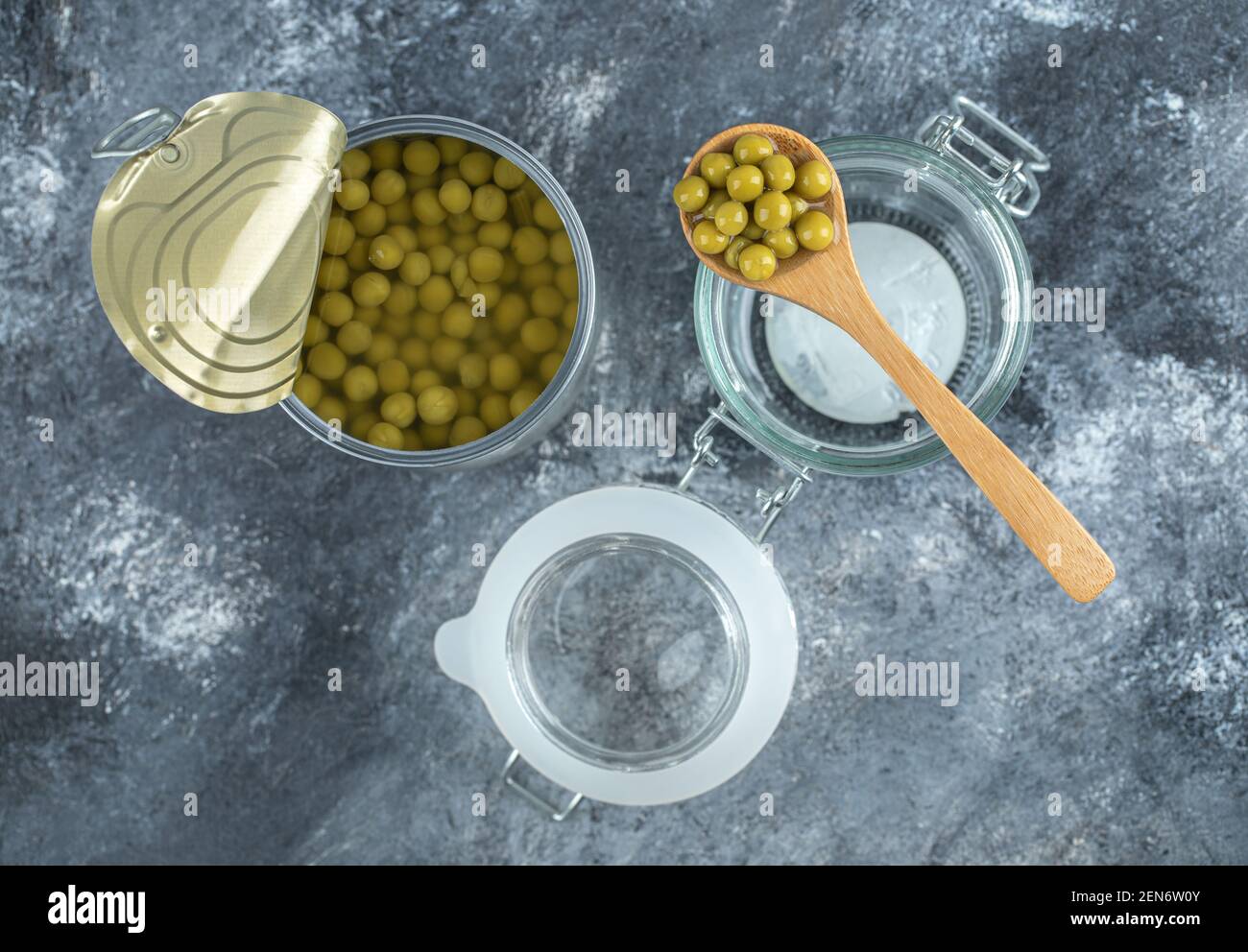 Opened olive tin with jar over grey background Stock Photo Alamy