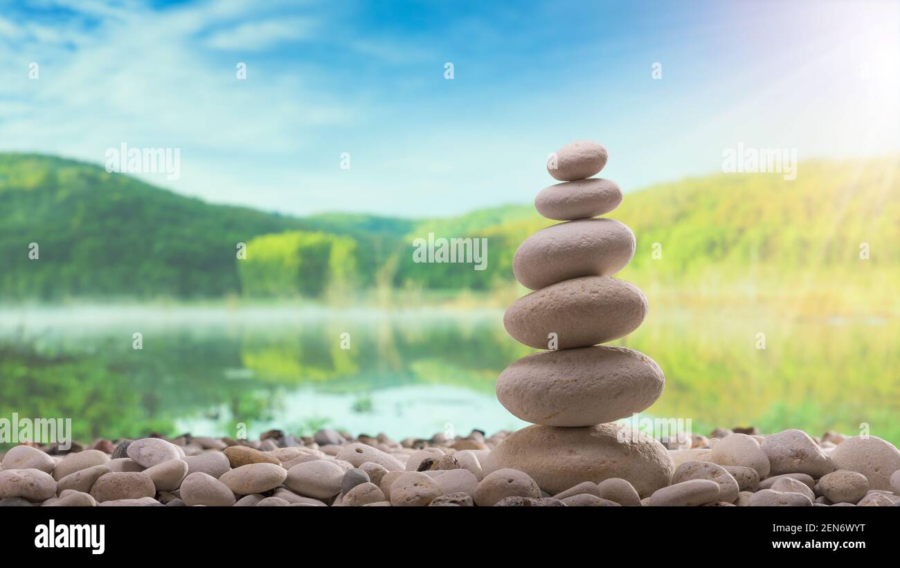 Stone tower. Blurred background lake Stock Photo