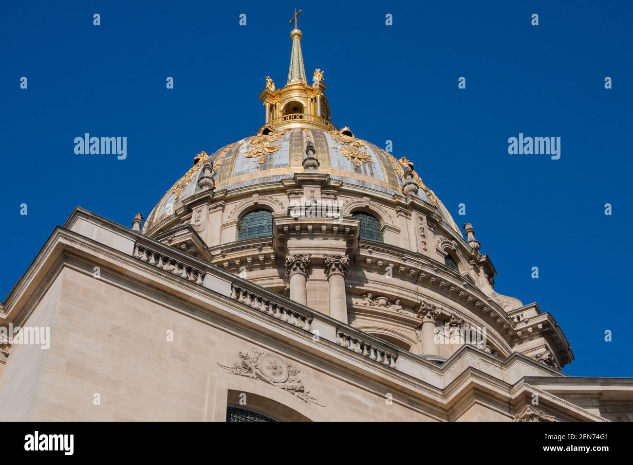 Top detail of golden Dôme des Invalides (Invalids Dome) former church with Napoleon Bonaparte tomb in Paris, France under clear blue sky Stock Photo