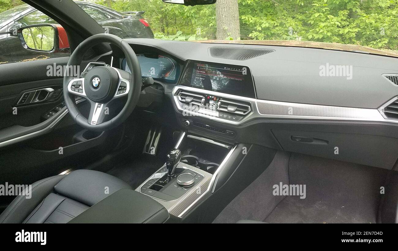 https://c8.alamy.com/comp/2EN7D4D/the-interior-of-the-2019-bmw-330i-is-nicely-understated-the-console-is-busy-with-remote-infotainment-controller-mode-button-and-onoff-button-but-a-monostable-shifter-helps-create-enough-space-for-storage-cubbies-photo-by-henry-paynethe-detroit-newstnssipa-usa-2EN7D4D.jpg