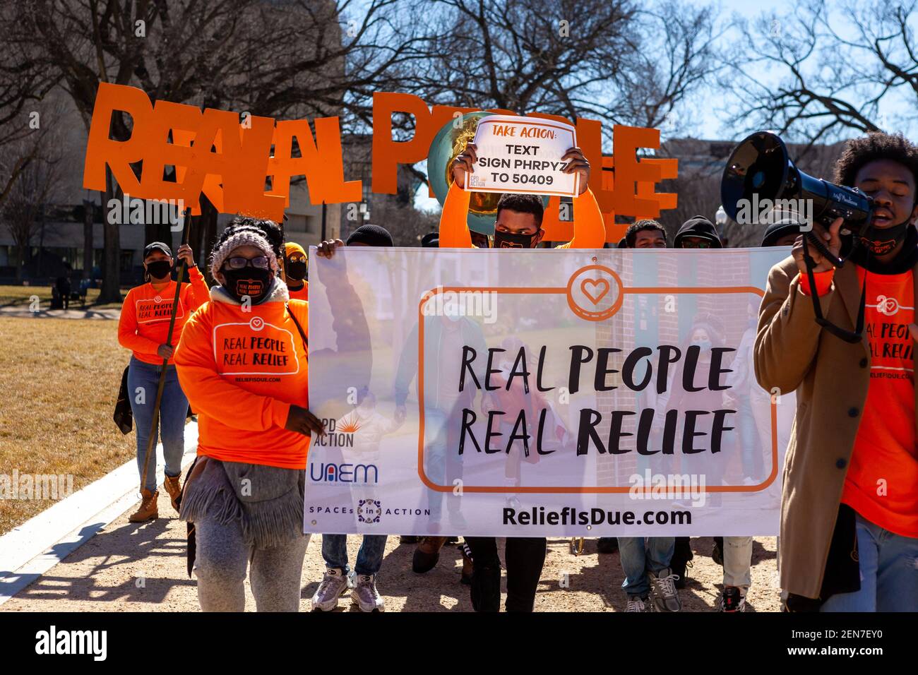 Washington, DC, USA, 25 February, 2021.  Pictured: Protesters at the Real People Real Relief rally for economic relief from covid begin their short march to the Capitol.   They called for Congress to make regular payments to everyone in the US and create a path to citizenship for undocumented residents.  Credit: Allison C Bailey/Alamy Live News Stock Photo