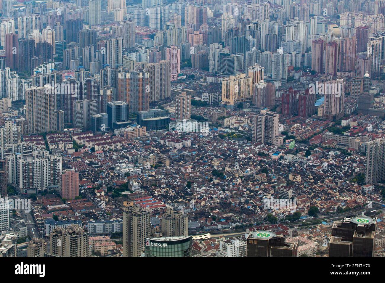 Residential houses in longtang are embraced by skyscrapers and high