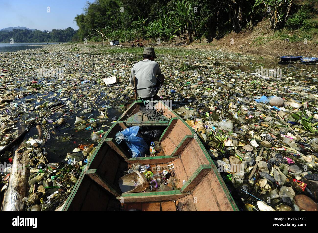 An Indonesian man salvages valuable items from the polluted Citarum river in Cihampelas, Indonesia, West Bandung regency on June 26, 2019. According data from River Basin Research Station (BBWS) Citarum and Environmental Agency (DLH) West Java estimate that around 20.462 tonnes garbage and 340.000 tonnes toxic waste per day into Citarium River. (Photo by Bukbisj Candra Ismeth Bey/Sipa USA) Stock Photo