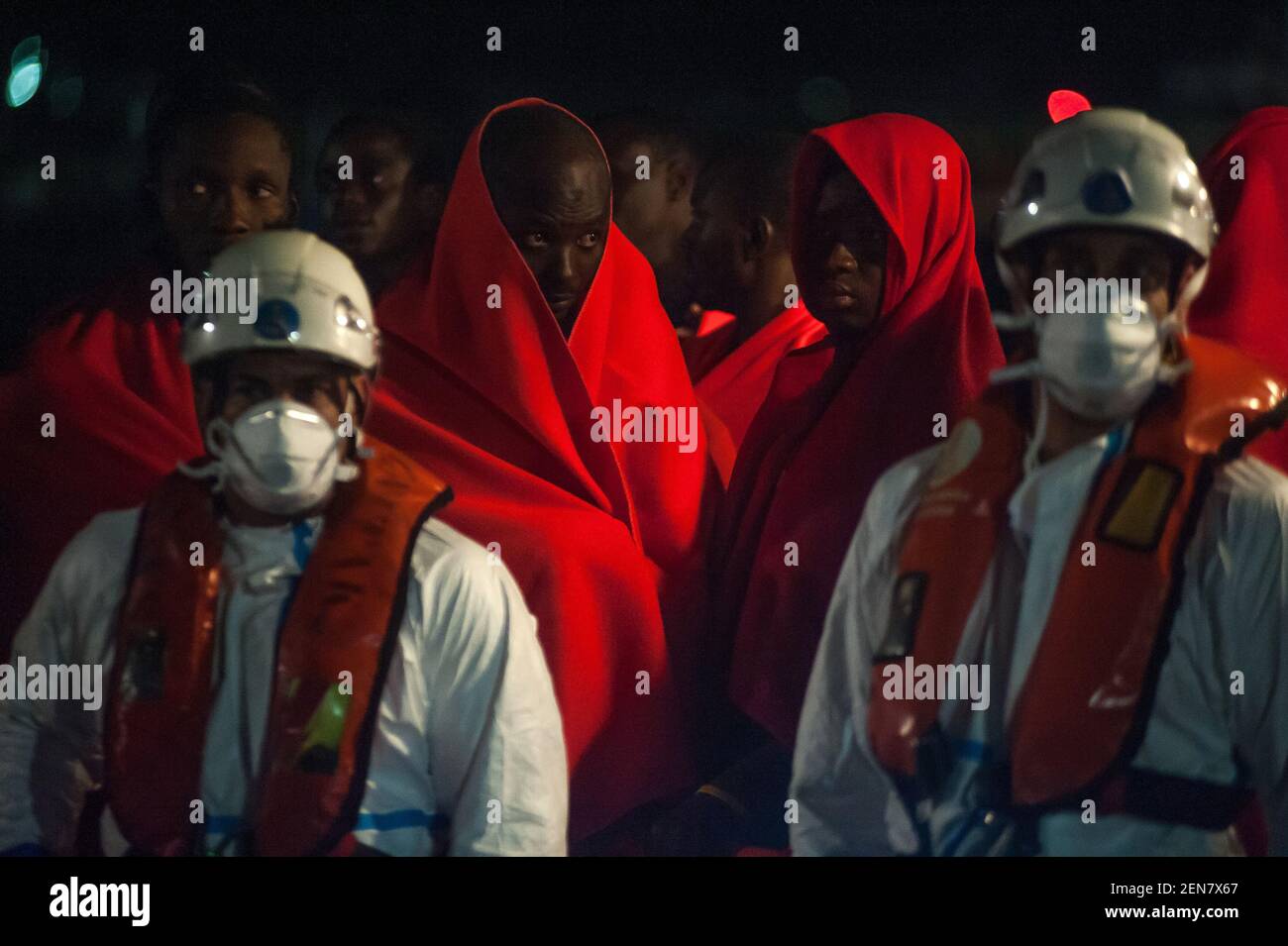 Migrants on a rescue boat as they wait to disembark after their arrival ...