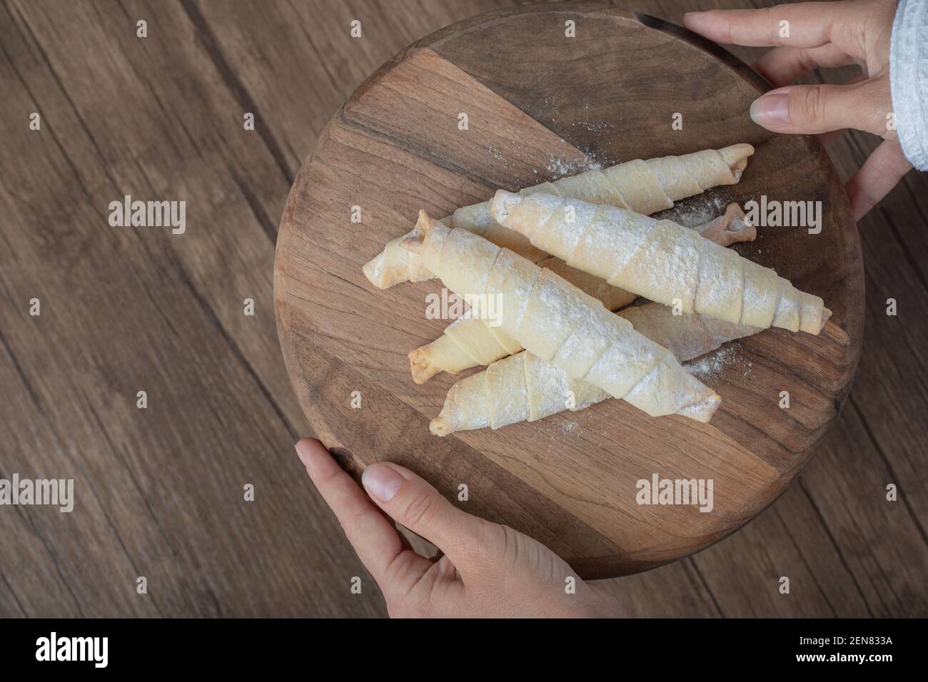 Holding mutaki cookies on a wooden board in the hand Stock Photo