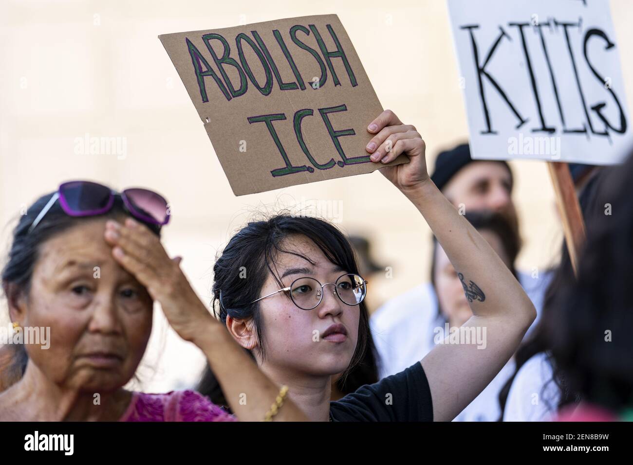 Protester holds a sign that says Abolish ICE (Immigration and Customs Enforcement) during a symbolic funeral procession in honor of migrants who died attempting to cross the border into the U.S. or while in the custody of Customs and Border Protection. Los Angeles, California on July 1, 2019. Organizers called the rally Homeland Security Kills Rally. (Photo by Ronen Tivony) *** Please Use Credit from Credit Field *** Stock Photo