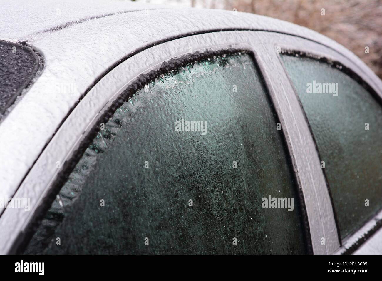Frozen car windows, auto glass after a freezing rain. How to unfreeze
