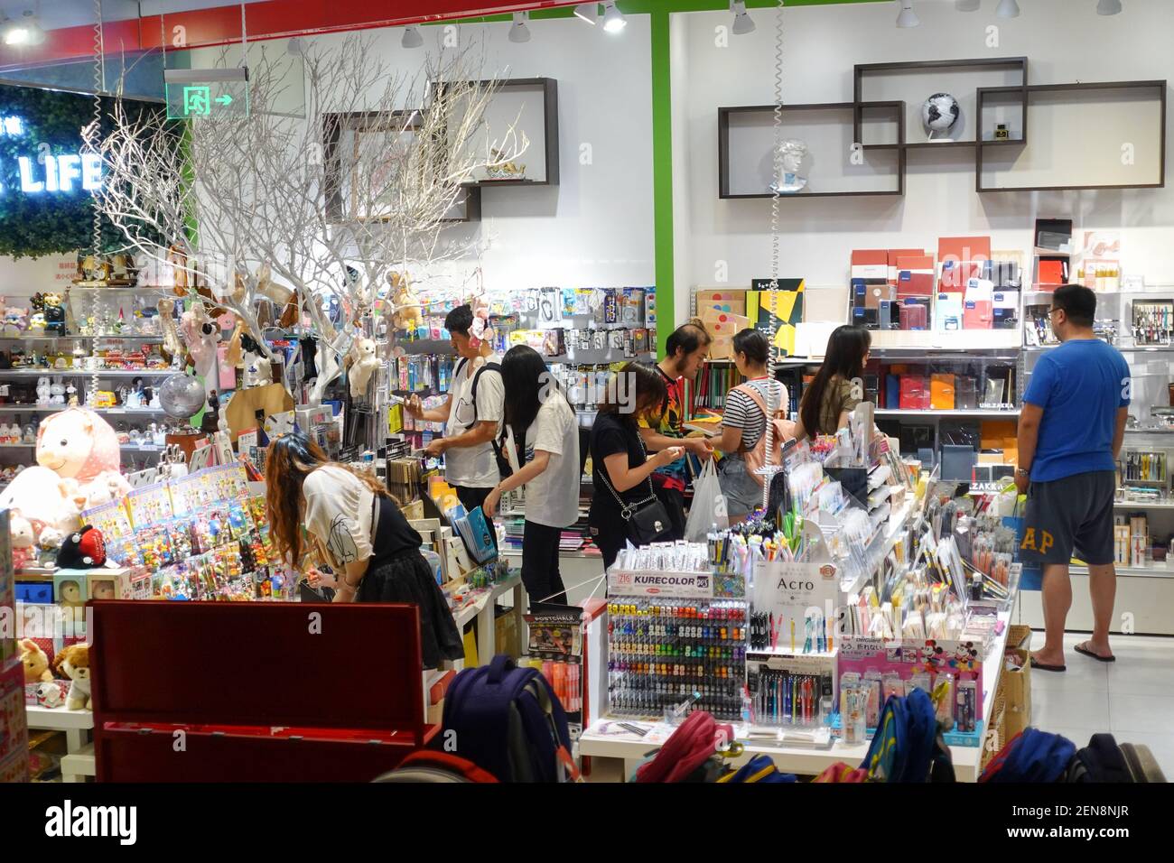 Customers shop at the Shanghai Takashimaya department store due to