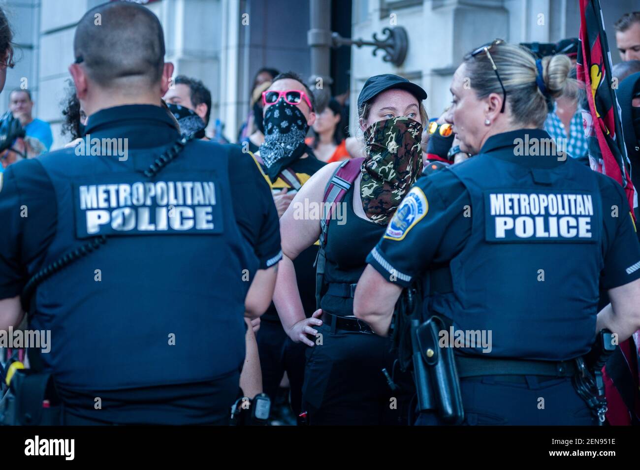 Metropolitian Police blocking Antifa members from the Trump Hotel in Washington D.C. on July 6, 2019. After the Demand Free Speech rally in Freedom plaza in the morning, the same organizers held a 'VIP Lounge Event' at the Trump Hotel in Washington D.C. on Saturday, July 6, 2019. Attendees entering the venue were greeted by Antifa members. Metropolitan police were quick to separate the opposing groups. One Antifa member was arrested in the process. Stock Photo