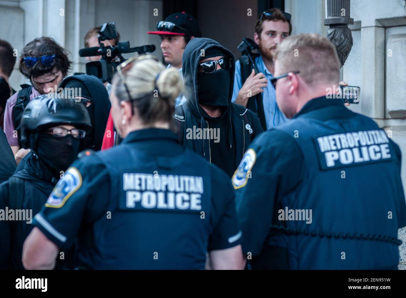 Metropolitian Police blocking Antifa members from the Trump Hotel in Washington D.C. on July 6, 2019. After the Demand Free Speech rally in Freedom plaza in the morning, the same organizers held a 'VIP Lounge Event' at the Trump Hotel in Washington D.C. on Saturday, July 6, 2019. Attendees entering the venue were greeted by Antifa members. Metropolitan police were quick to separate the opposing groups. One Antifa member was arrested in the process. Stock Photo