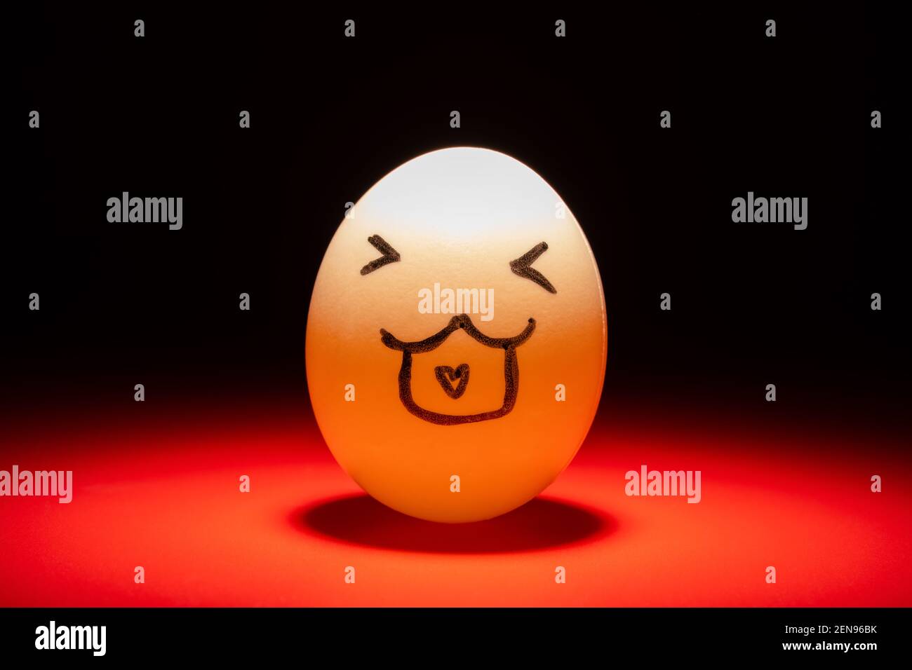 cute smiling egg face highlighted in dark Stock Photo
