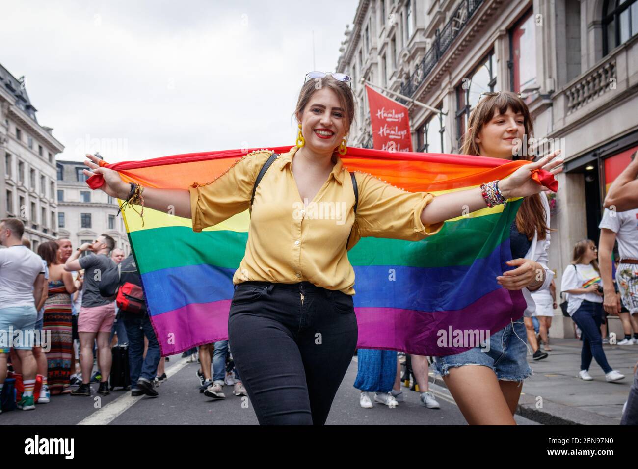A woman opening up her rainbow flag during the parade. The Pride in ...