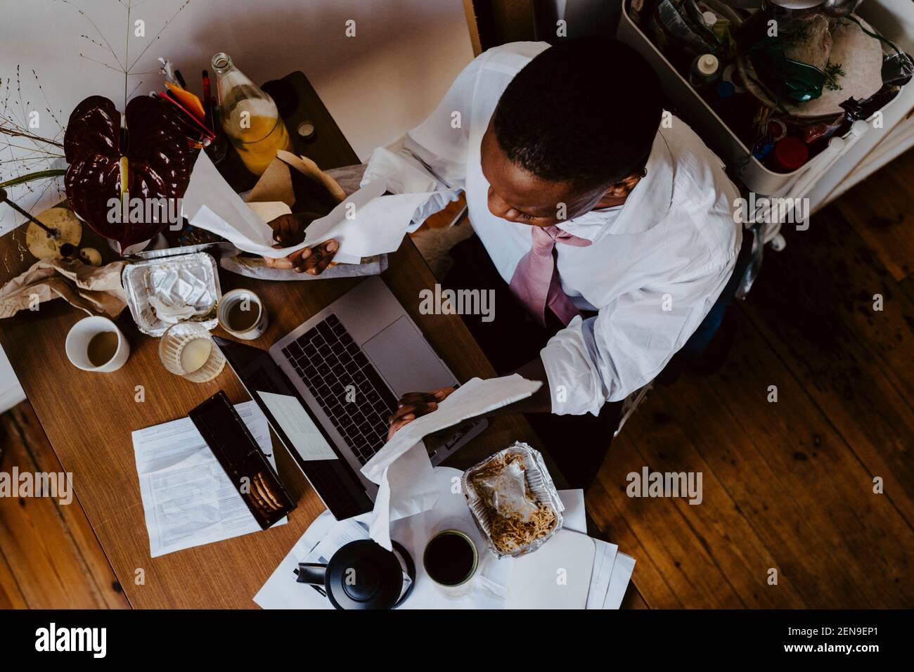 Directly above shot of of male entrepreneur using laptop at table in living room Stock Photo
