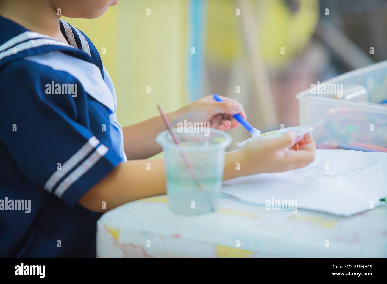 Cute little toddler girl painting with paints color and brush on the ...