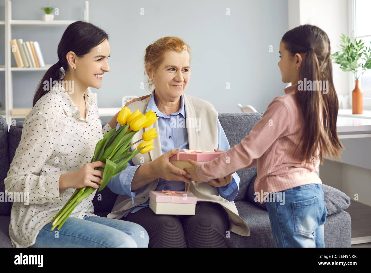 Happy grandma getting flowers and presents from her loving family on
