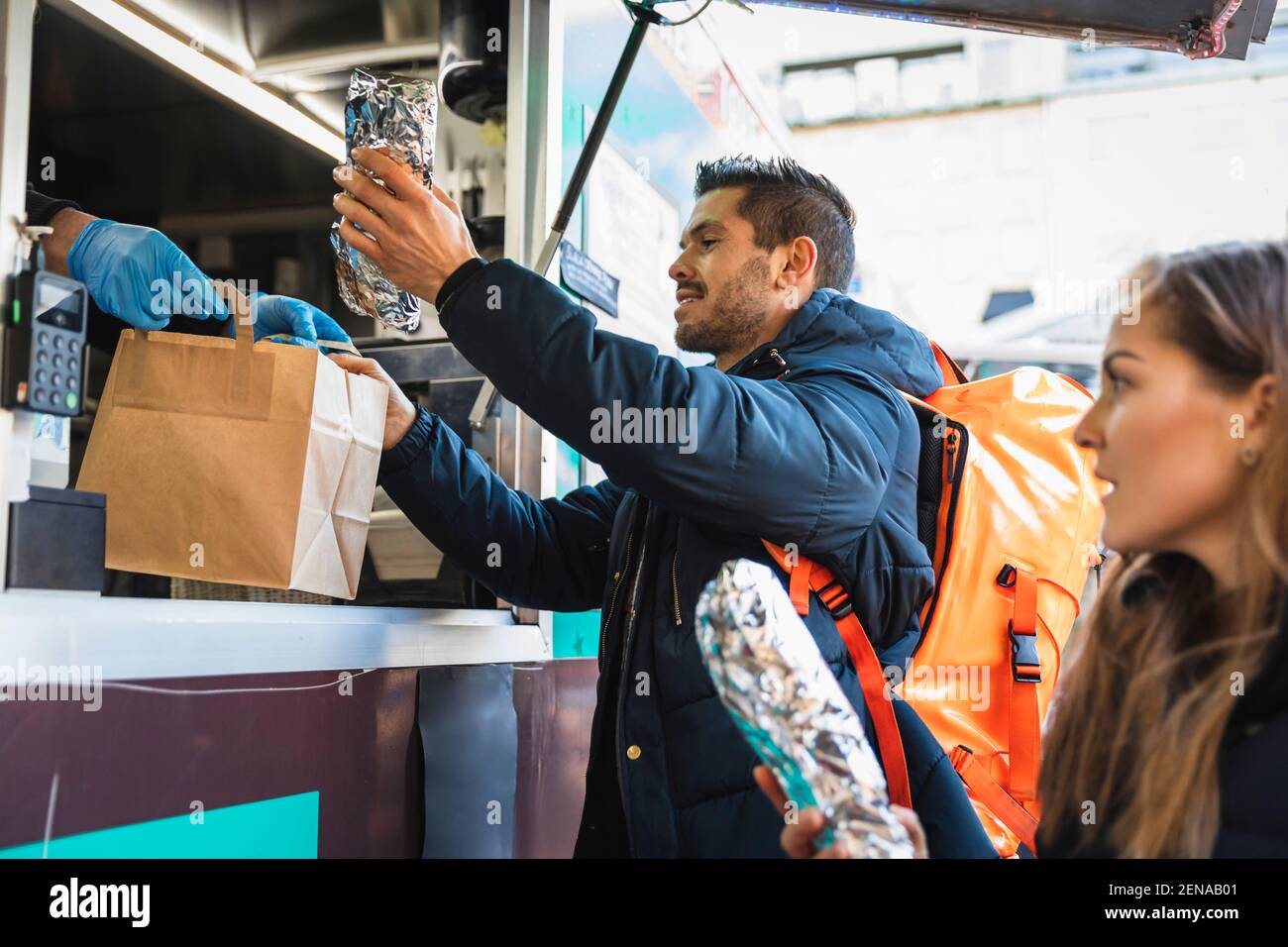 Customers purchasing food from owner at food truck Stock Photo