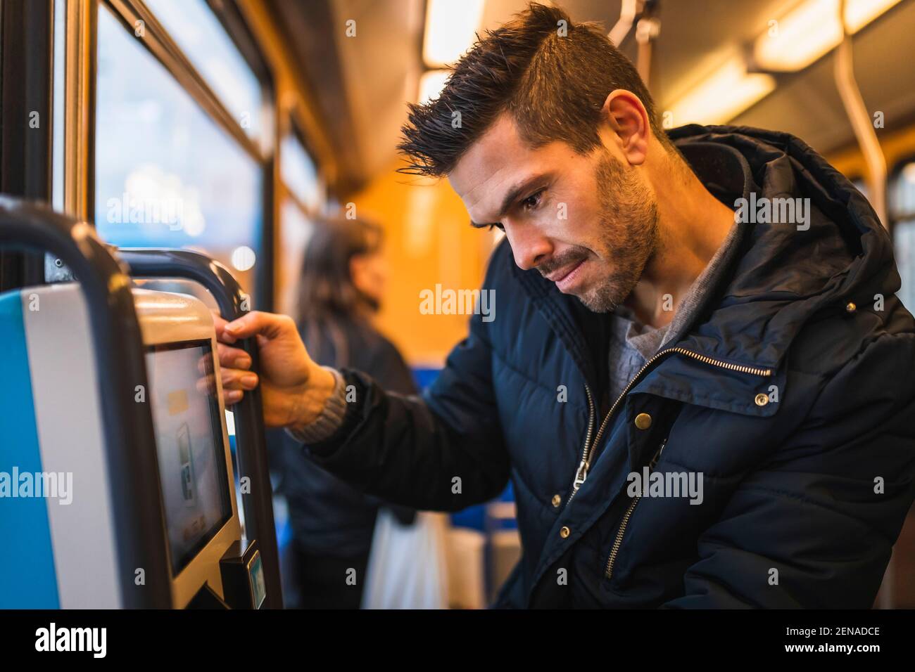 Smiling man buying ticket while commuting through tram Stock Photo - Alamy