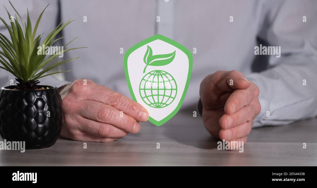 Concept of planet protection with paper shield protected by male hand ...
