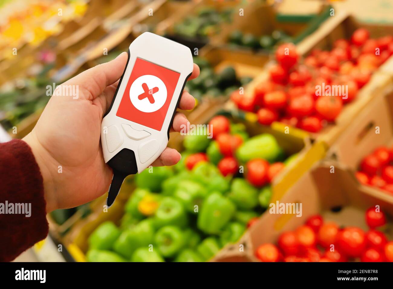 Use nitrate tester in market to buy organic vegetables and fruits. Inspection of farm products to high content of nitrates and nitrites. Dangerous exc Stock Photo