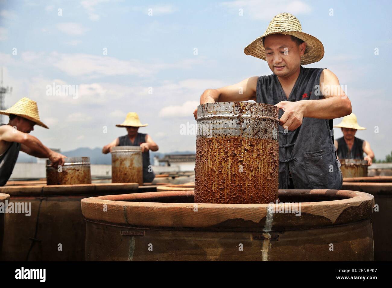 Chinese artisan Chen Xudong stirs the 