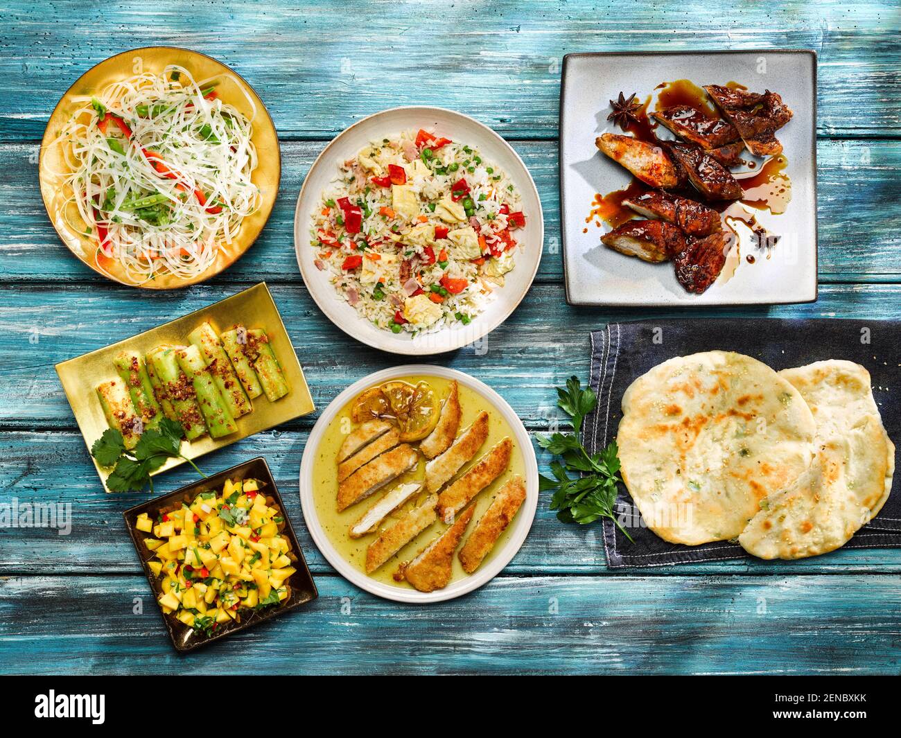Lemon Chicken, Cucumber Salad, Special Fried Rice, Barbecued Char Sui Pork with Sticky Sauce, Asian Shredded Noodle Salad with Mango Relish Stock Photo