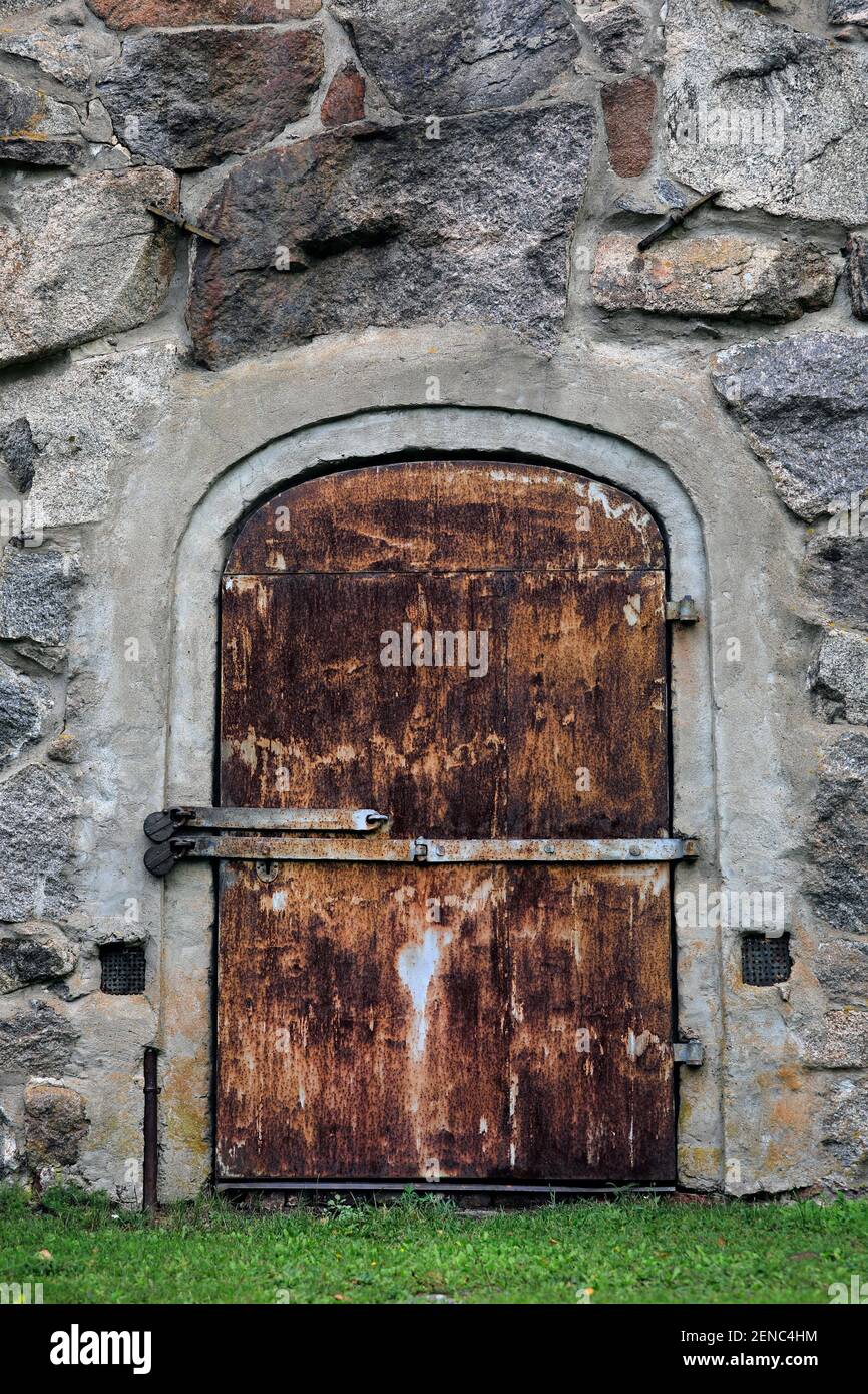 The front door of Pertteli Stone Granary, 1863, closed with two old padlocks with latch. Salo, Finland. Stock Photo