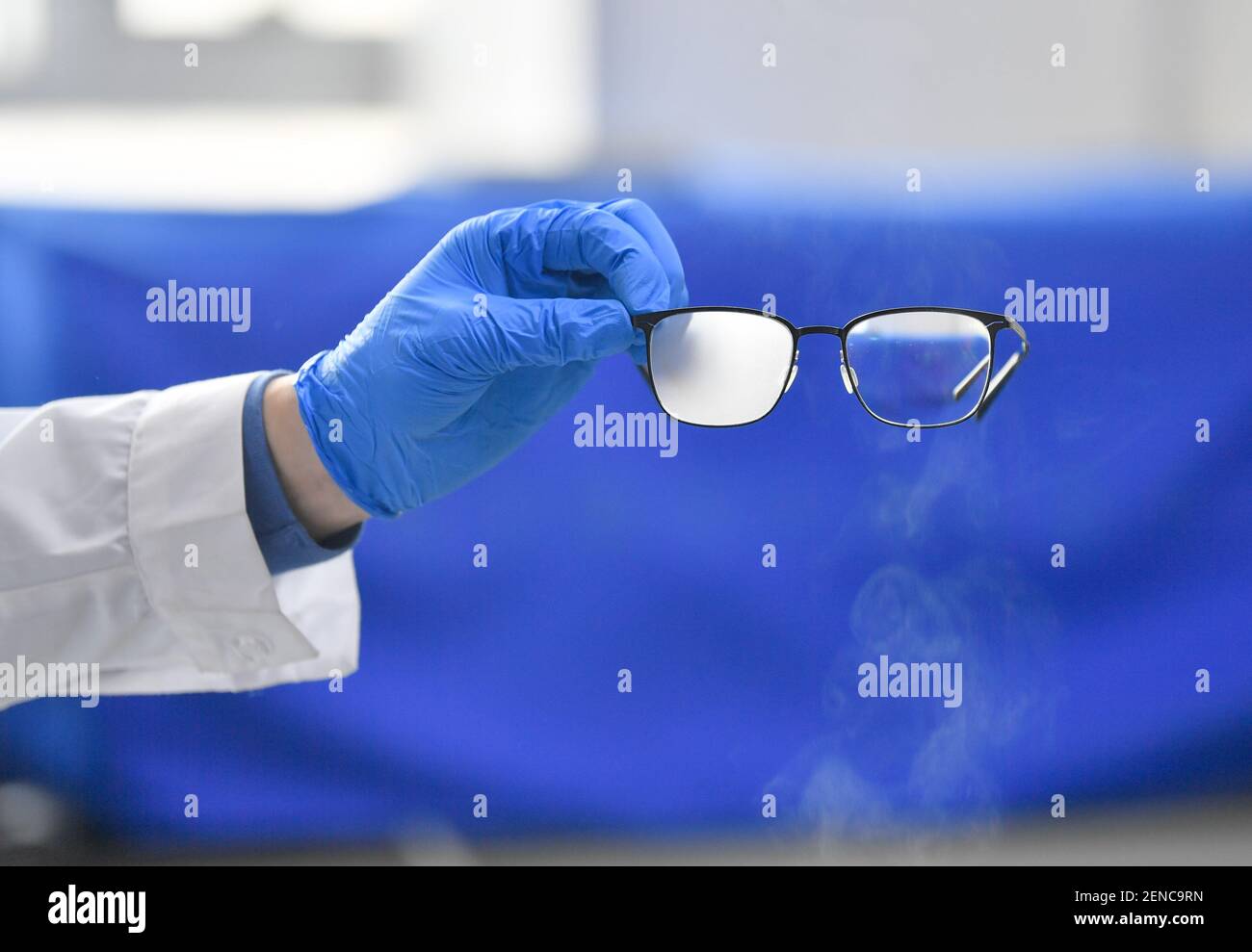 (210226) -- TIANJIN, Feb. 26, 2021 (Xinhua) -- A technician shows a lens treated by hydrophilic modified nano-coating technology and an untreated lens encountering vapor at the Research Center for Surface/Interfacial Micro/Nano-technology, Tsinghua University Tianjin Research Institute for Advanced Equipment, in north China's Tianjin, Feb. 24, 2021. Tsinghua University Tianjin Research Institute for Advanced Equipment was founded in October 2014. It combines the advantages of science, technology, human resources from Tsinghua University and the industrial and regional strength of Tianjin, serv Stock Photo