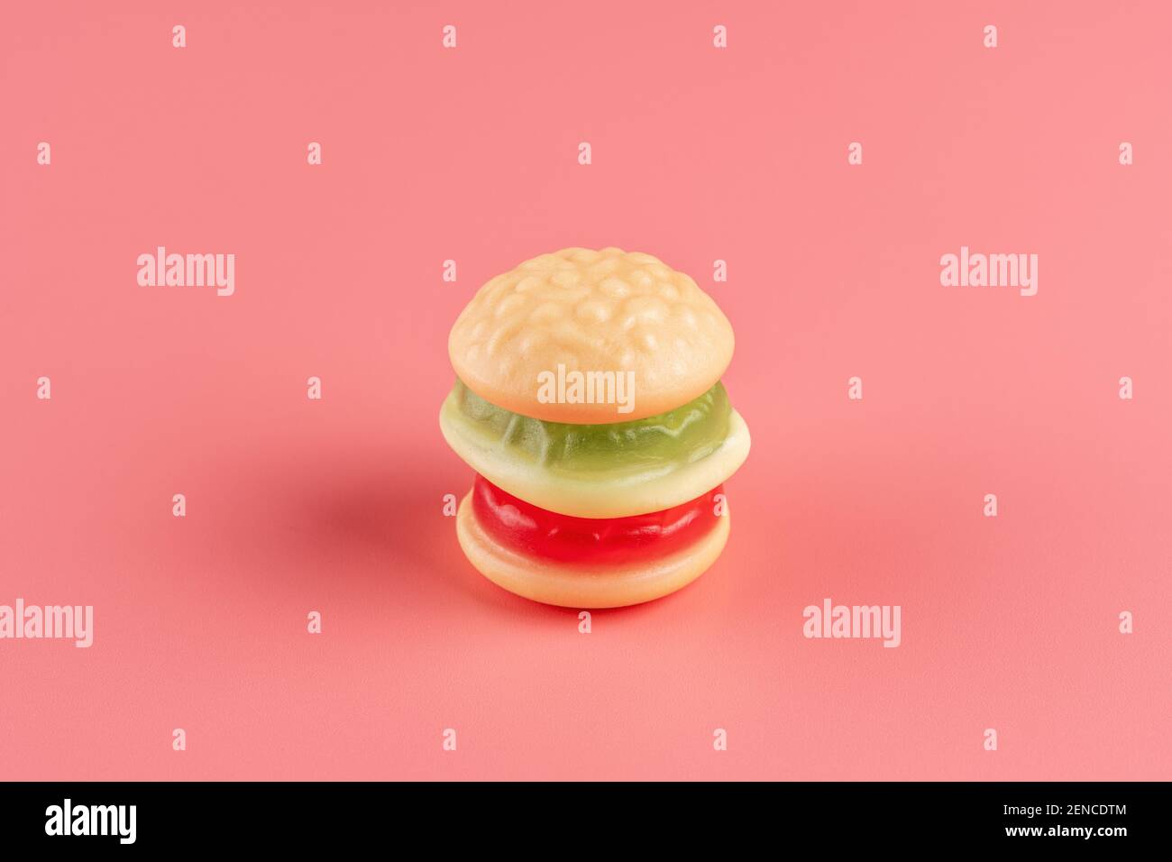 Colorful candy hamburger on pink background. Minimal food concept. Stock Photo