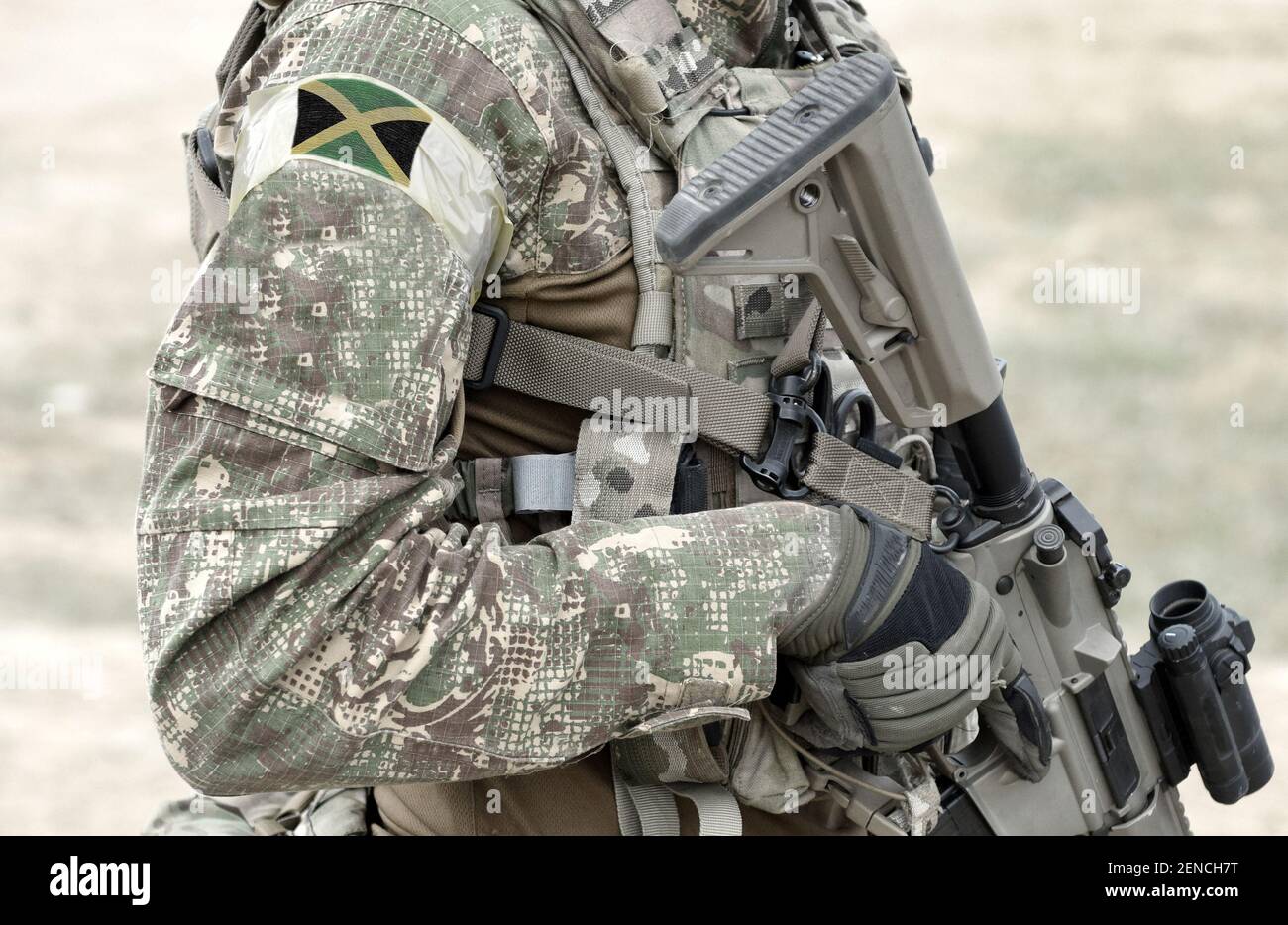 Soldier With Assault Rifle And Flag Of Jamaica On Military Uniform. Collage  Stock Photo - Alamy