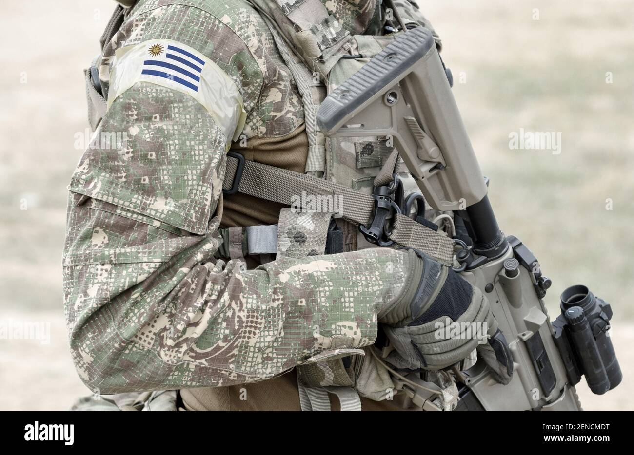 Soldier with assault rifle and flag of Uruguay on military uniform. Collage  Stock Photo - Alamy