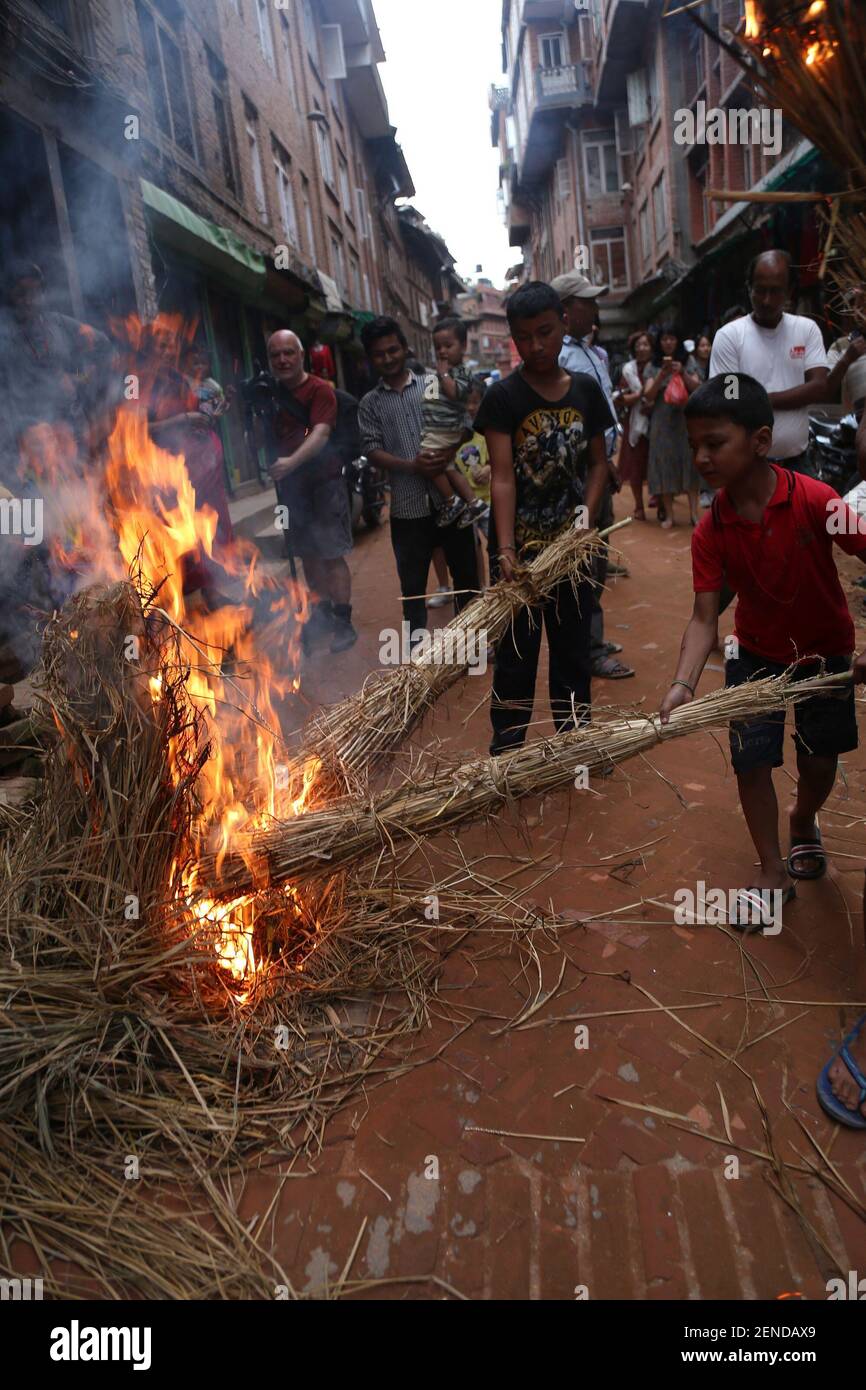 Local kids from Newar community get ready with straw fire to burn during  the celebration of Ghantakarna festival in Bhaktapur, Nepal on July 30,  2019. Ghantakarna festival is celebrated in defeat of