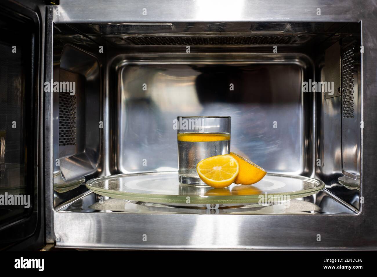 Process of cleaning or purifying the microwave oven by lemon and water Stock Photo