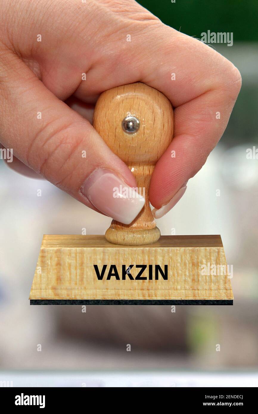 Frauenhand mit Stempel, Holzstempel, Aufschrift, Vakzin, Impfung, Schutzimpfung, Stock Photo