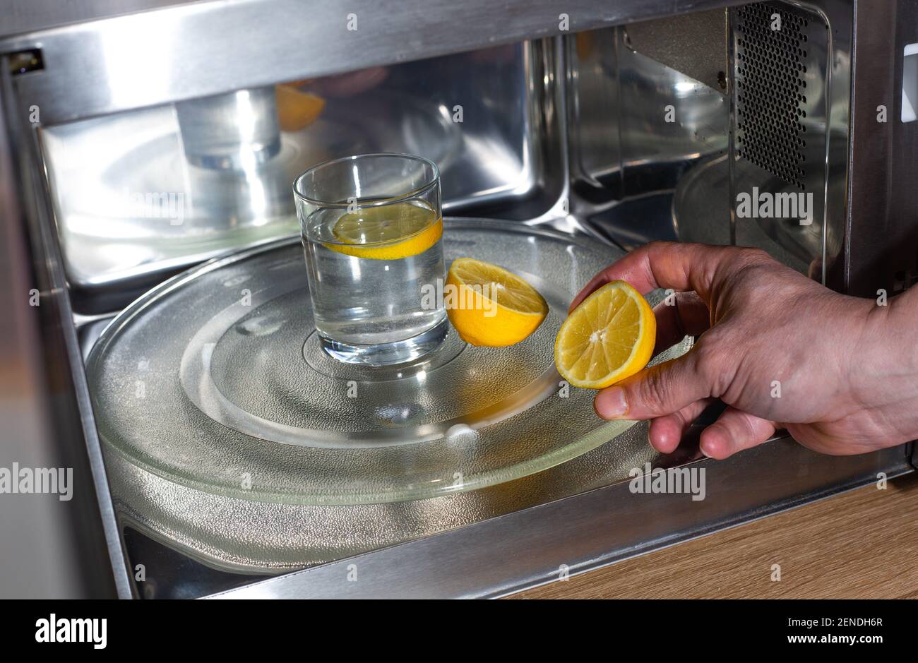 Process of cleaning or purifying the microwave oven by lemon and water Stock Photo