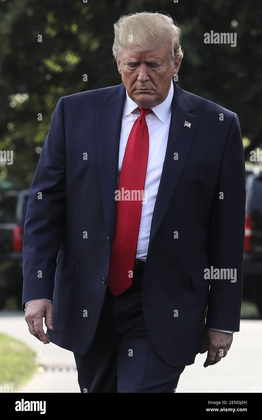 President Donald Trump walks out of the Oval Office before boarding ...