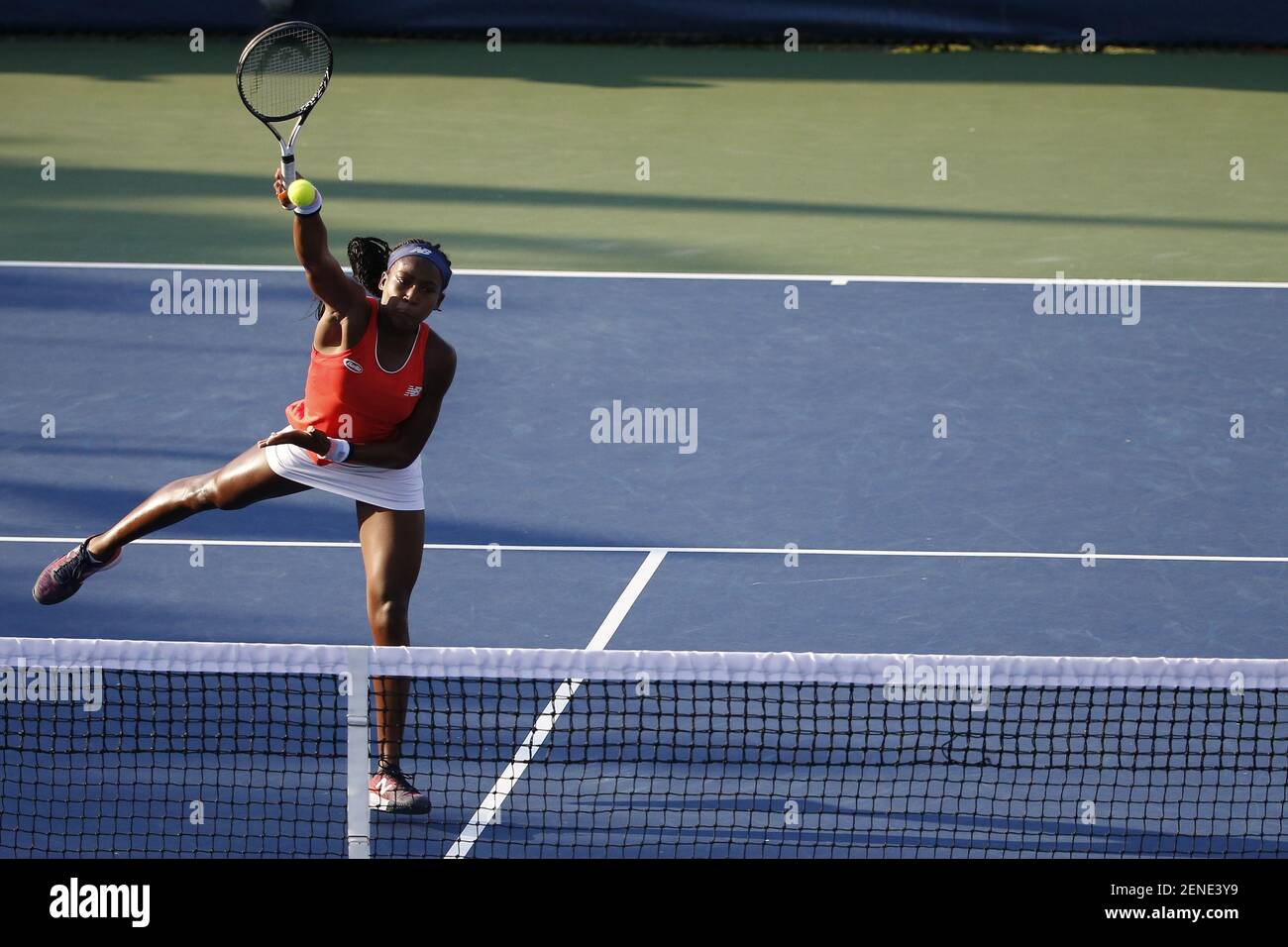 Aug 3, 2019; Washington, D.C., USA; Cori Gauff of the United States hits an  overhead against Fanny Stollar of Hungary and Maria Sanchez of the United  States (both not pictured) in the