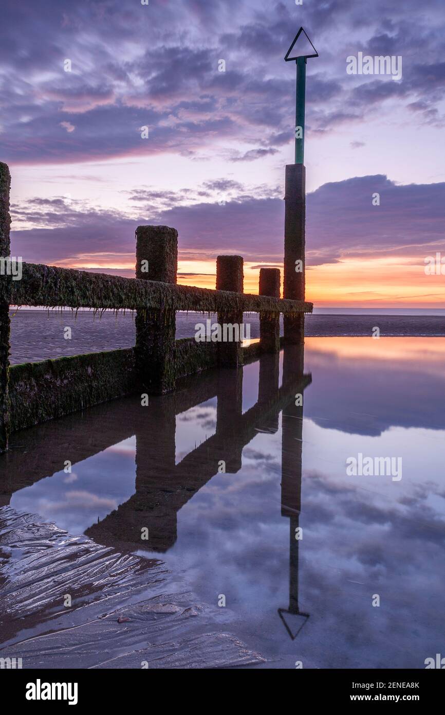 Sunset over Rhyl beach at low tide on the North Wales coast Stock Photo