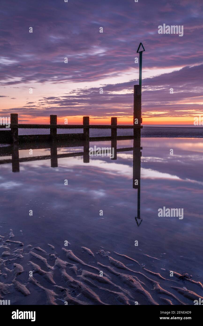 Sunset over Rhyl beach at low tide on the North Wales coast Stock Photo