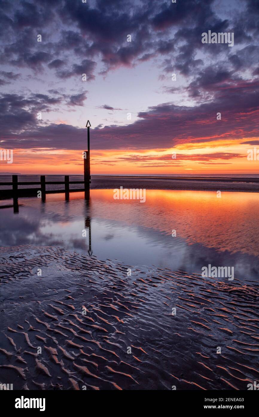 Sunset over Rhyl beach at low tide on the North Wales coast Stock Photo