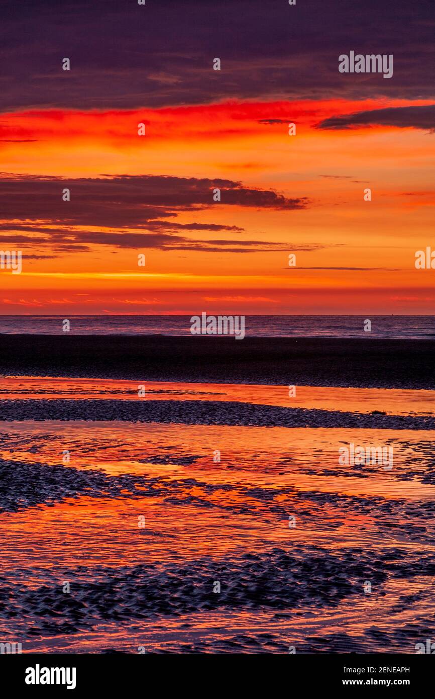 Sunset over Rhyl beach at low tide on the North Wales coast Stock Photo