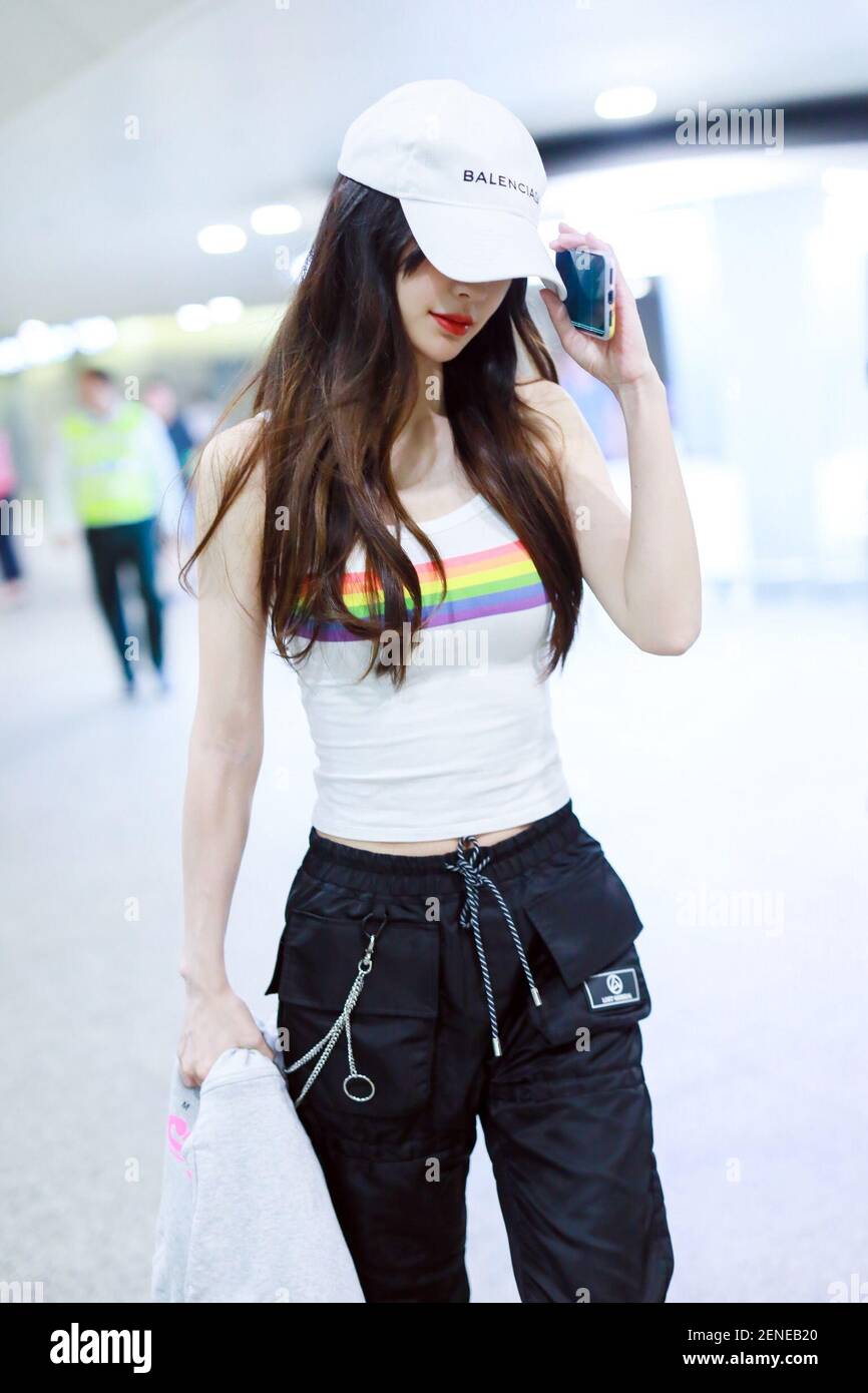 Hong Kong actress Angelababy arrives at the Shanghai Hongqiao International  Airport after landing in Shanghai, China, 4 August 2019. T-shirt:  Abercrombie Fitch Hoodie: adidas Handbag: Dior Pants: Lost General Shoes: Dr.  Martens (