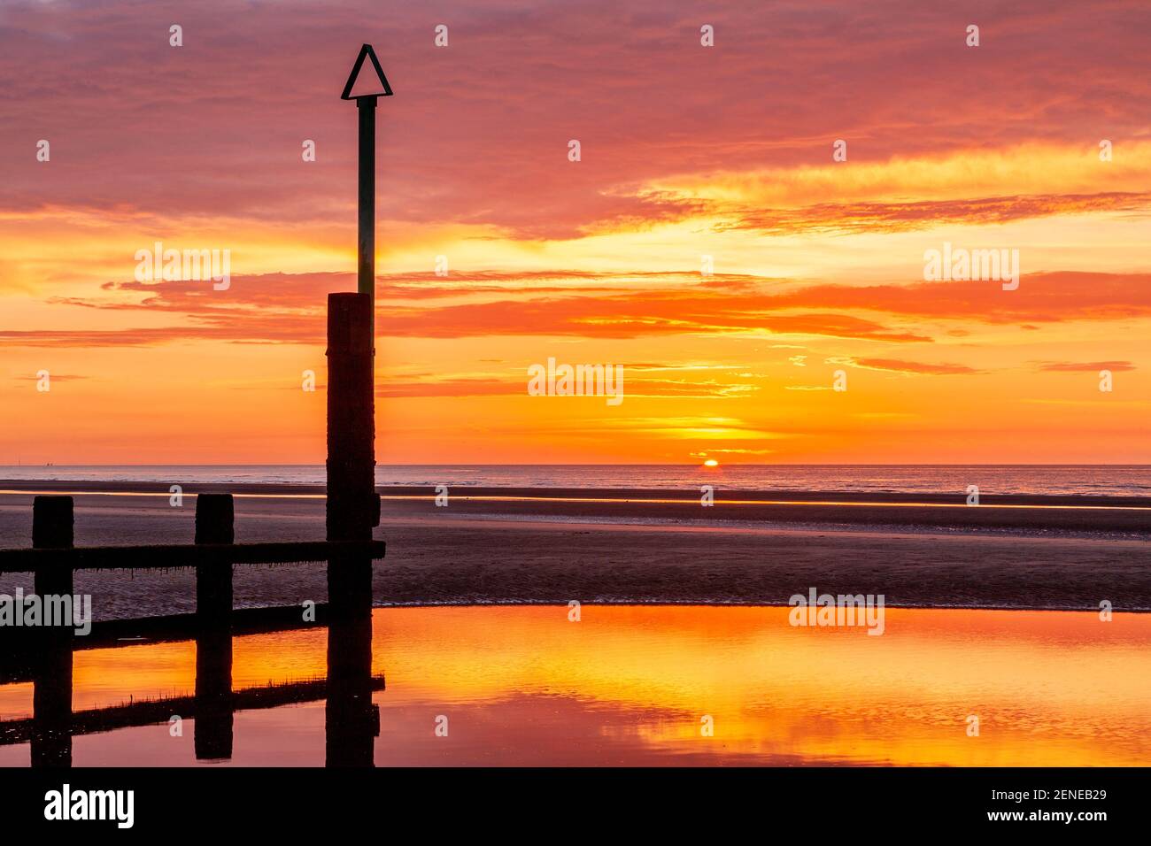 Sunset over Rhyl beach at low tide on the North Wales coast Stock Photo