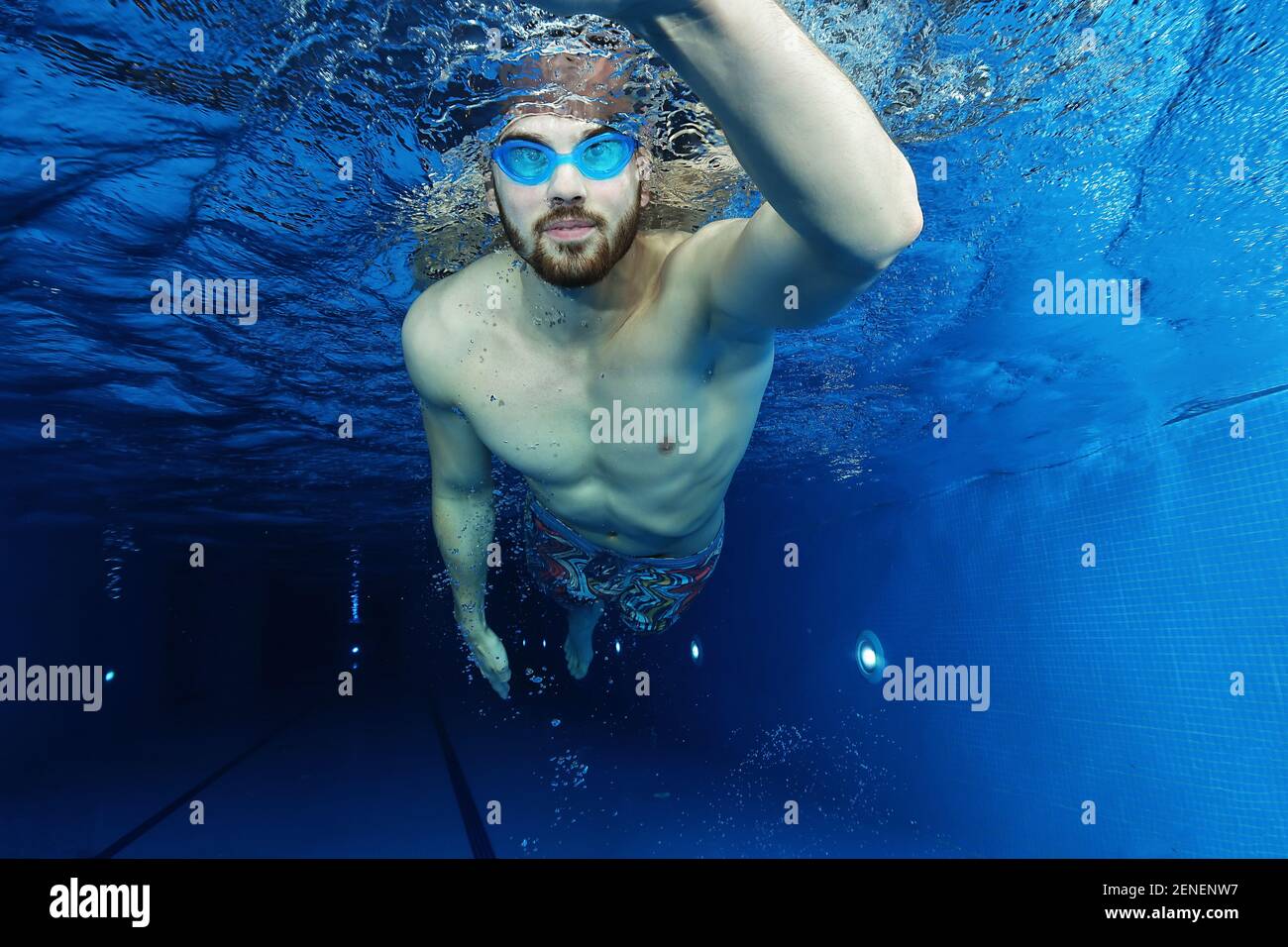 Handsome young man in the swimming pool swimming, underwater view Stock ...