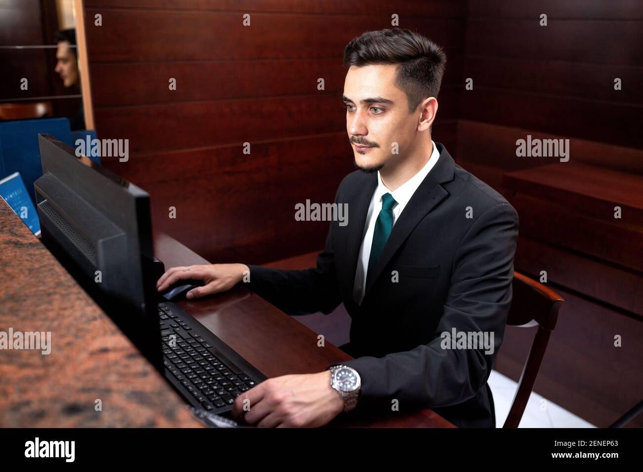 Young receptionist coordinating frontdesk activities, hotel service