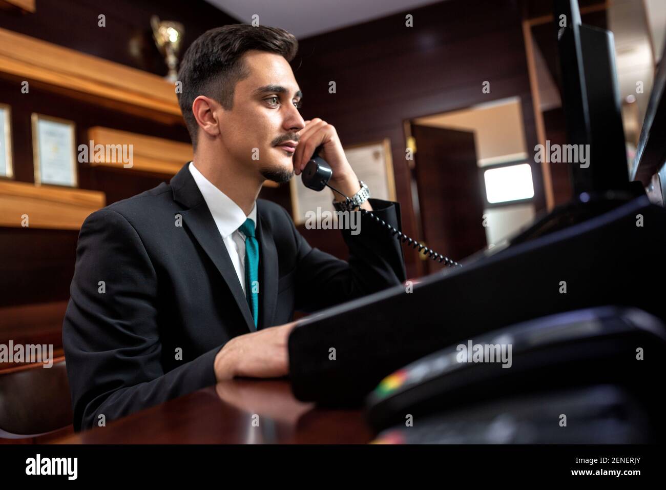 Hotel worker welcoming guests hi-res stock photography and images - Alamy