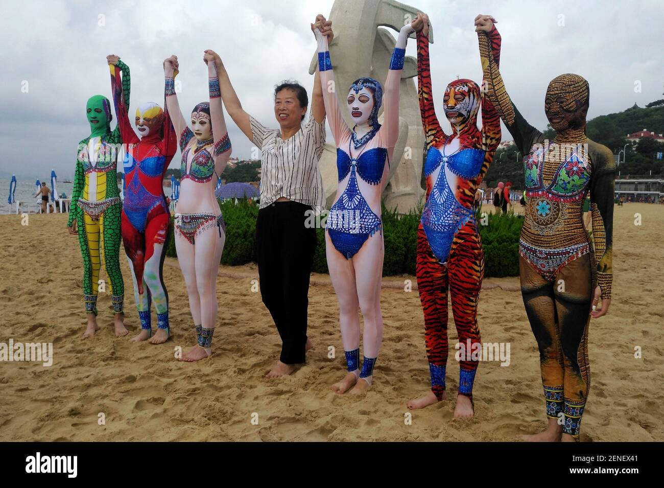 Chinese facekini inventor Zhang Shifan introduces new creations of facekini  collection featuring Chinese cultural elements on the beach during a press  conference in Qingdao city, east China's Shandong province, 5 August 2019.