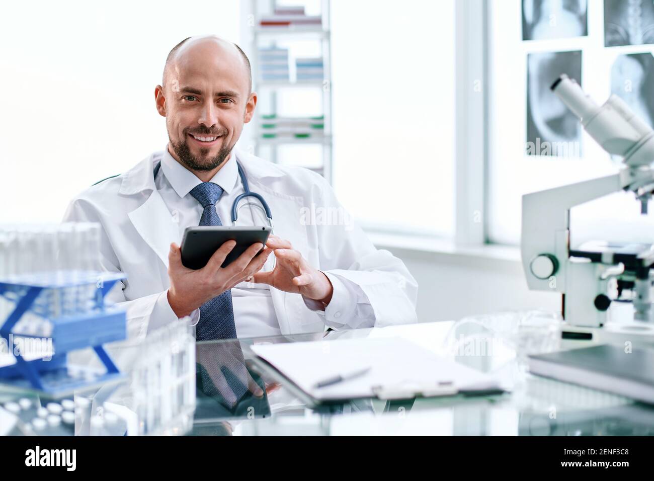 smiling young scientist works in a laboratory. Stock Photo