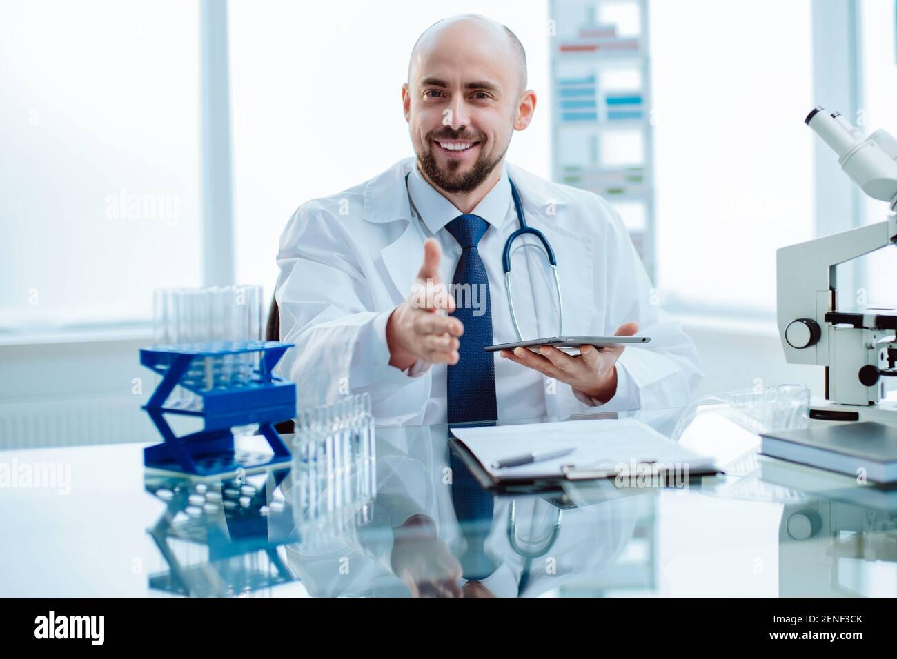 smiling young scientist works in a laboratory. Stock Photo