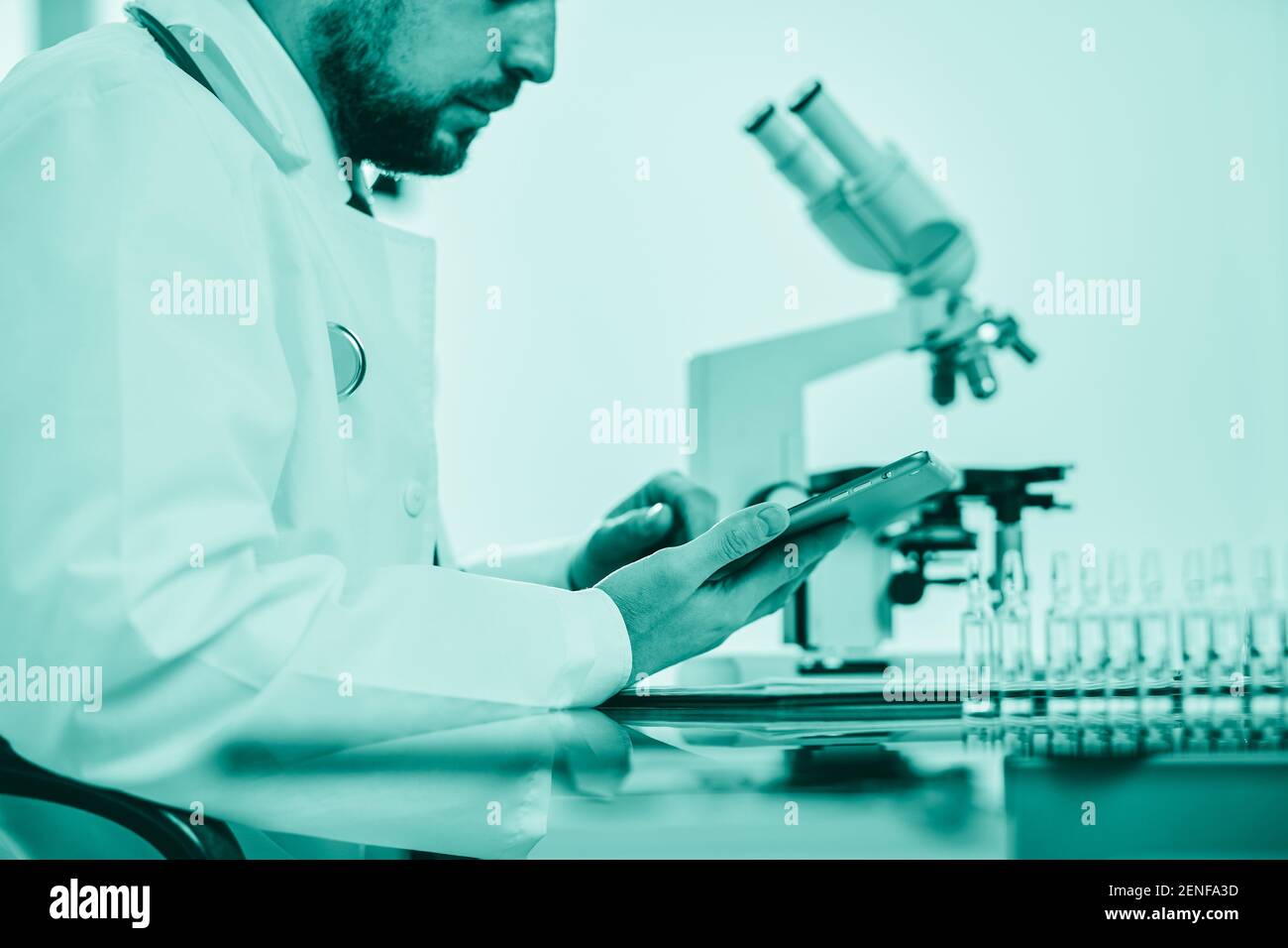 scientist using a digital tablet while working in the lab. Stock Photo
