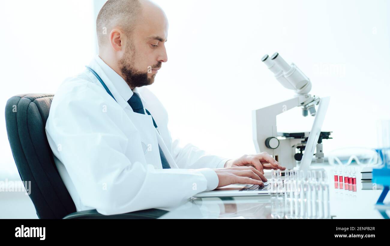 scientist using a laptop in a medical lab. Stock Photo
